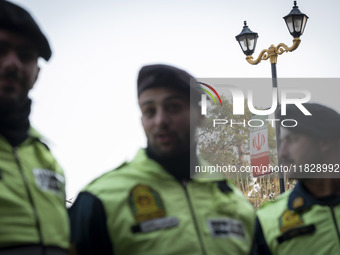 Iranian policemen stand guard outside the Turkish embassy during a protest against Turkish President Recep Tayyip Erdogan and his diplomacy...