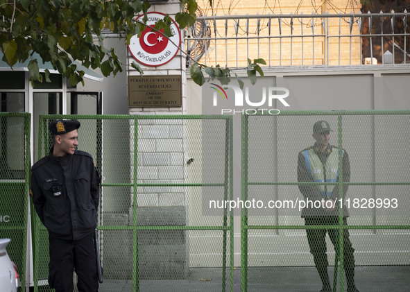 Iranian policemen stand guard outside the Turkish embassy during a protest against Turkish President Recep Tayyip Erdogan and his diplomacy...