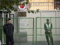 Iranian policemen stand guard outside the Turkish embassy during a protest against Turkish President Recep Tayyip Erdogan and his diplomacy...