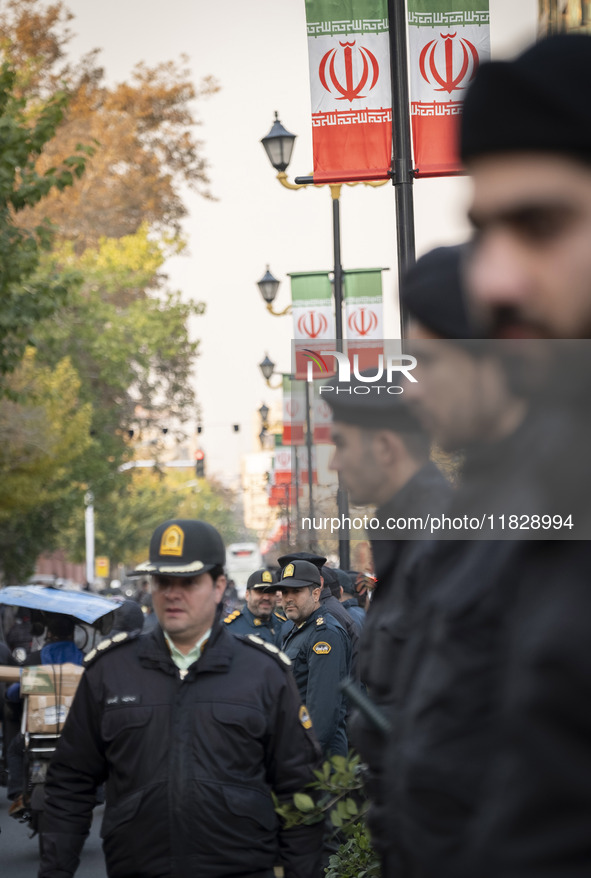 Iranian policemen stand guard outside the Turkish embassy during a protest against Turkish President Recep Tayyip Erdogan and his diplomacy...