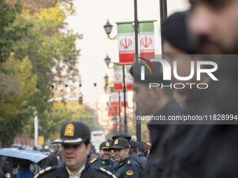 Iranian policemen stand guard outside the Turkish embassy during a protest against Turkish President Recep Tayyip Erdogan and his diplomacy...