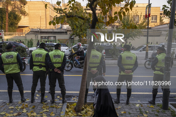 Iranian policemen stand guard outside the Turkish embassy during a protest against Turkish President Recep Tayyip Erdogan and his diplomacy...