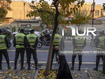 Iranian policemen stand guard outside the Turkish embassy during a protest against Turkish President Recep Tayyip Erdogan and his diplomacy...