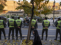 Iranian policemen stand guard outside the Turkish embassy during a protest against Turkish President Recep Tayyip Erdogan and his diplomacy...