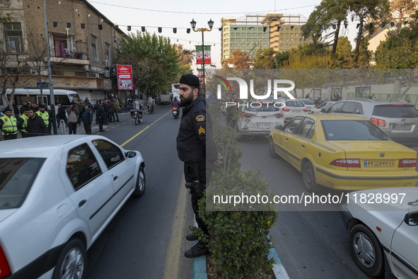 An Iranian policeman stands guard outside the Turkish embassy during a protest against Turkish President Recep Tayyip Erdogan and his diplom...