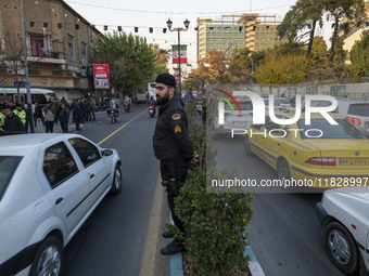 An Iranian policeman stands guard outside the Turkish embassy during a protest against Turkish President Recep Tayyip Erdogan and his diplom...