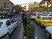 An Iranian policeman stands guard outside the Turkish embassy during a protest against Turkish President Recep Tayyip Erdogan and his diplom...