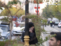 A veiled Iranian woman speaks on her cellphone during a protest against Turkish President Recep Tayyip Erdogan and his diplomacy regarding r...