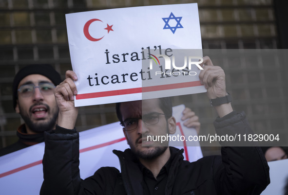 An Iranian protester holds up an anti-Turkish placard while participating in a protest against Turkish President Recep Tayyip Erdogan and hi...