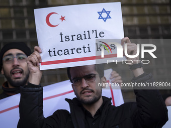 An Iranian protester holds up an anti-Turkish placard while participating in a protest against Turkish President Recep Tayyip Erdogan and hi...