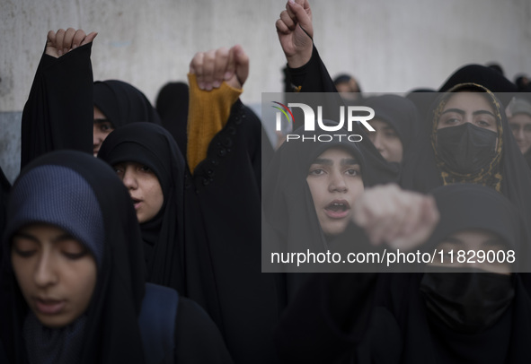 Veiled Iranian protesters shout anti-Turkish President slogans while participating in a protest against Turkish President Recep Tayyip Erdog...