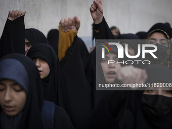 Veiled Iranian protesters shout anti-Turkish President slogans while participating in a protest against Turkish President Recep Tayyip Erdog...