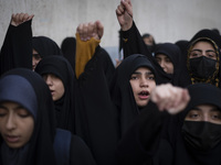 Veiled Iranian protesters shout anti-Turkish President slogans while participating in a protest against Turkish President Recep Tayyip Erdog...