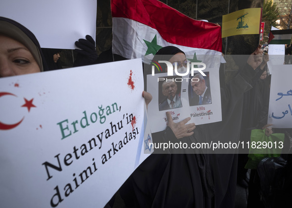 Veiled Iranian protesters hold an anti-Turkish placard and a poster featuring portraits of Turkish President Recep Tayyip Erdogan and Israel...