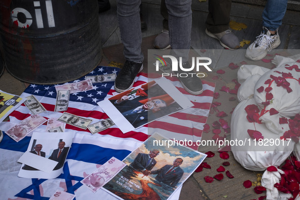 An Iranian protester stands on the U.S. flag covered with copies of U.S. Dollar and Turkish Lira banknotes, and posters featuring portraits...