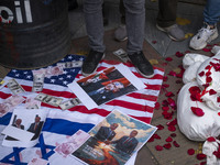 An Iranian protester stands on the U.S. flag covered with copies of U.S. Dollar and Turkish Lira banknotes, and posters featuring portraits...