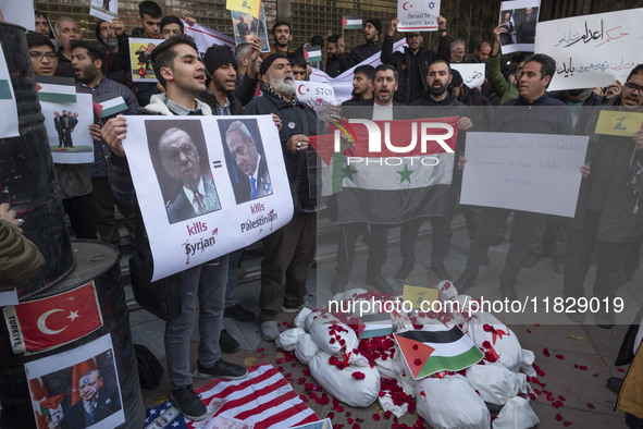 Iranian protesters hold a Syrian flag and an anti-Turkish President placard featuring portraits of the Turkish President and Israeli Prime M...