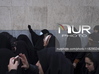 A veiled Iranian protester shouts anti-Turkish President slogans while participating in a protest against Turkish President Recep Tayyip Erd...