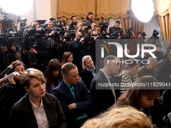 Reporters cover a joint briefing of the President of Ukraine, Volodymyr Zelenskyy, and the Federal Chancellor of Germany, Olaf Scholz, in Ky...