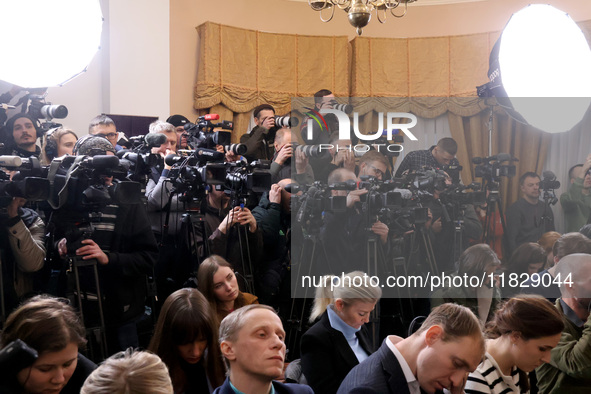 Reporters cover a joint briefing of the President of Ukraine, Volodymyr Zelenskyy, and the Federal Chancellor of Germany, Olaf Scholz, in Ky...