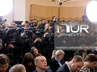 Reporters cover a joint briefing of the President of Ukraine, Volodymyr Zelenskyy, and the Federal Chancellor of Germany, Olaf Scholz, in Ky...