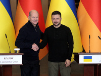 In Kyiv, Ukraine, on December 2, 2024, President of Ukraine Volodymyr Zelenskyy shakes hands with Federal Chancellor of Germany Olaf Scholz...