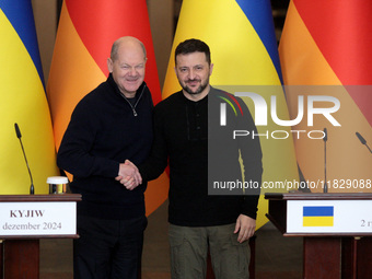 In Kyiv, Ukraine, on December 2, 2024, President of Ukraine Volodymyr Zelenskyy shakes hands with Federal Chancellor of Germany Olaf Scholz...