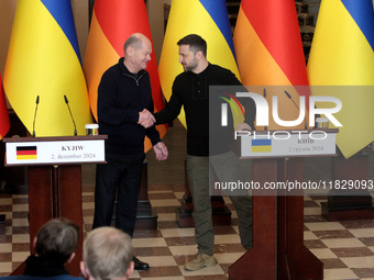 In Kyiv, Ukraine, on December 2, 2024, President of Ukraine Volodymyr Zelenskyy shakes hands with Federal Chancellor of Germany Olaf Scholz...