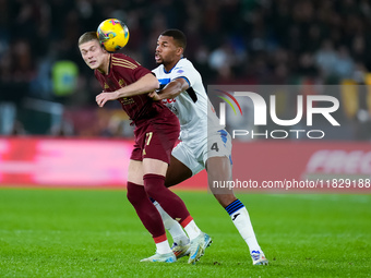 Isak Hien of Atalanta BC and Artem Dovbyk of AS Roma compete for the ball during the Serie A Enilive match between AS Roma and Atalanta BC a...