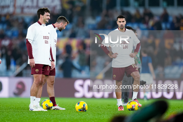 Zeki Celik of AS Roma and Mats Hummels wear a shirt in support of Edoardo Bove of ACF Fiorentina during the Serie A Enilive match between AS...