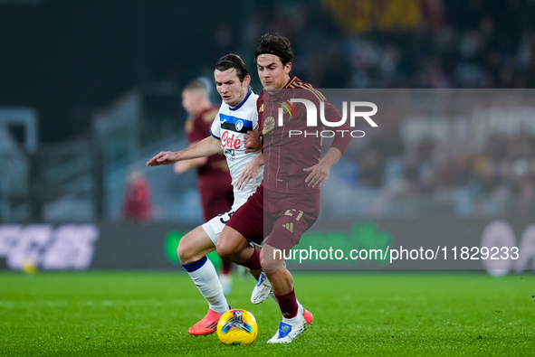 Paulo Dybala of AS Roma and Marten de Roon of Atalanta BC compete for the ball during the Serie A Enilive match between AS Roma and Atalanta...