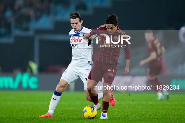 Paulo Dybala of AS Roma and Marten de Roon of Atalanta BC compete for the ball during the Serie A Enilive match between AS Roma and Atalanta...