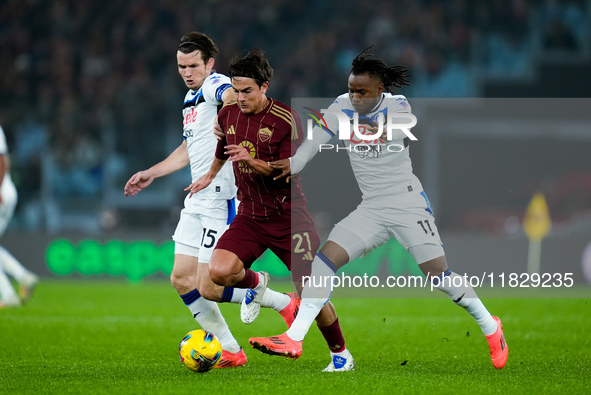 Paulo Dybala of AS Roma and Marten de Roon of Atalanta BC compete for the ball during the Serie A Enilive match between AS Roma and Atalanta...