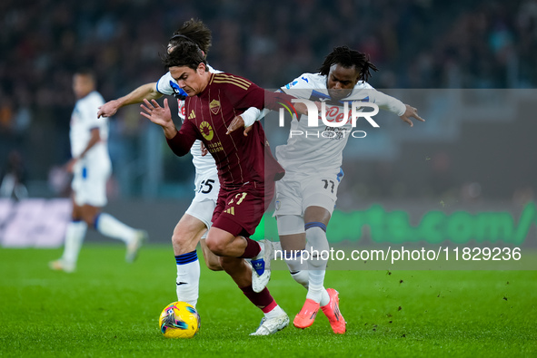 Paulo Dybala of AS Roma and Marten de Roon of Atalanta BC compete for the ball during the Serie A Enilive match between AS Roma and Atalanta...