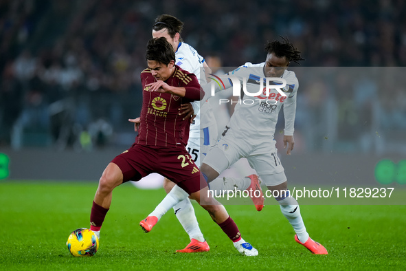 Paulo Dybala of AS Roma and Marten de Roon of Atalanta BC compete for the ball during the Serie A Enilive match between AS Roma and Atalanta...