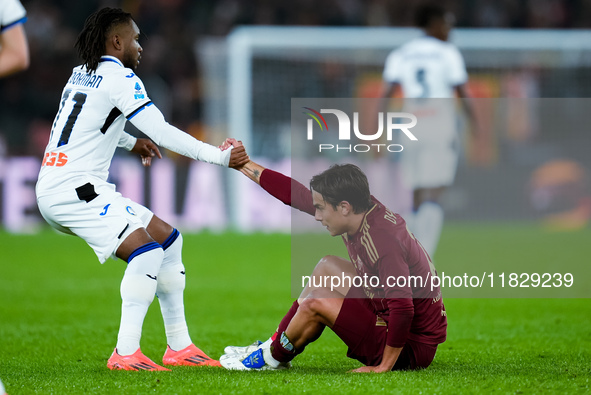 Ademola Lookman of Atalanta BC helps Paulo Dybala of AS Roma to rise up during the Serie A Enilive match between AS Roma and Atalanta BC at...