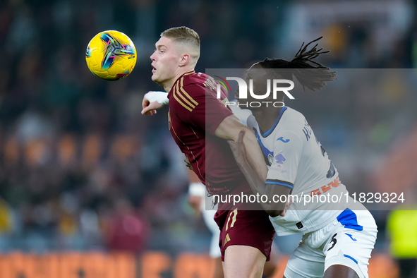 Artem Dovbyk of AS Roma and Isak Hien of Atalanta BC compete for the ball during the Serie A Enilive match between AS Roma and Atalanta BC a...