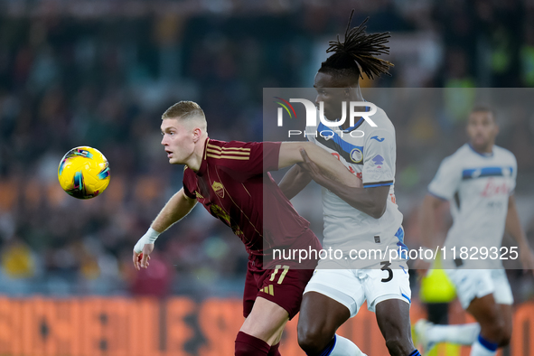 Artem Dovbyk of AS Roma and Isak Hien of Atalanta BC compete for the ball during the Serie A Enilive match between AS Roma and Atalanta BC a...