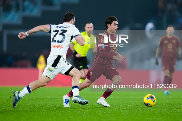 Paulo Dybala of AS Roma and Sead Kolasinac of Atalanta BC compete for the ball during the Serie A Enilive match between AS Roma and Atalanta...