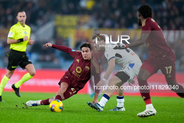 Paulo Dybala of AS Roma and Sead Kolasinac of Atalanta BC compete for the ball during the Serie A Enilive match between AS Roma and Atalanta...