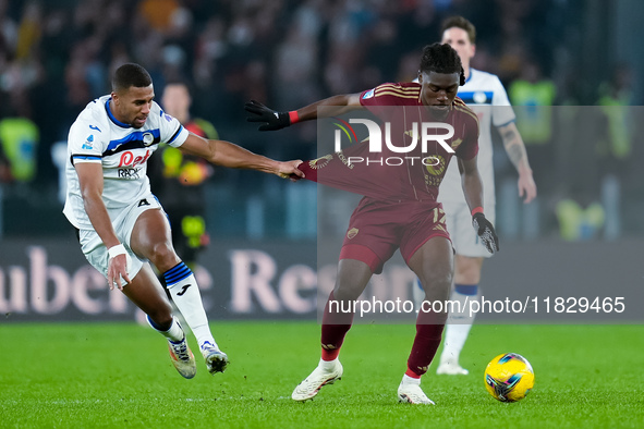 Isak Hien of Atalanta BC and Manu Kone' of AS Roma compete for the ball during the Serie A Enilive match between AS Roma and Atalanta BC at...