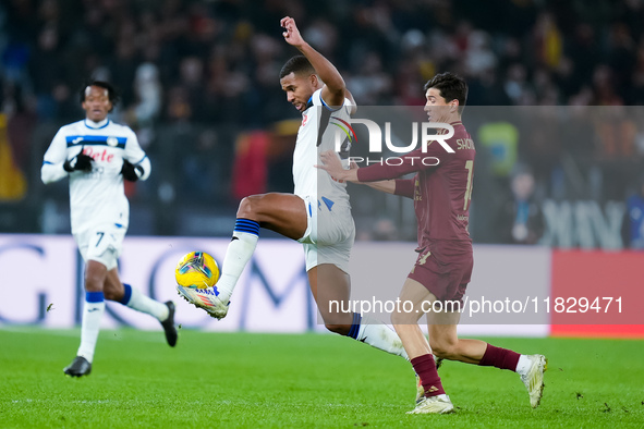 Isak Hien of Atalanta BC and Eldor Shomurodov of AS Roma compete for the ball during the Serie A Enilive match between AS Roma and Atalanta...