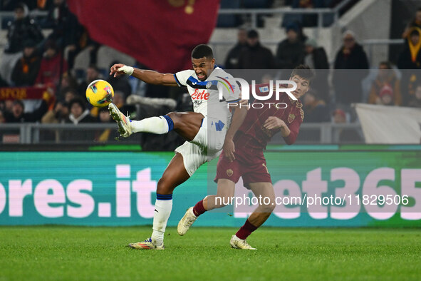 Isak Hien of Atalanta B.C. and Eldor Shomurodov of A.S. Roma are in action during the 14th day of the Serie A Championship between A.S. Roma...