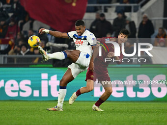 Isak Hien of Atalanta B.C. and Eldor Shomurodov of A.S. Roma are in action during the 14th day of the Serie A Championship between A.S. Roma...