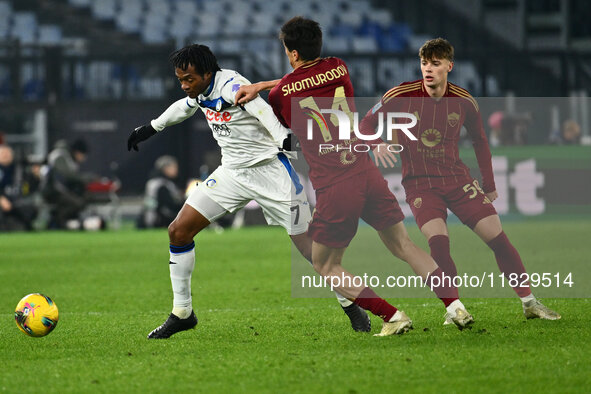 Juan Cuadrado of Atalanta B.C. and Eldor Shomurodov of A.S. Roma are in action during the 14th day of the Serie A Championship between A.S....