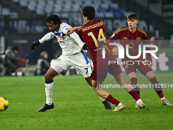 Juan Cuadrado of Atalanta B.C. and Eldor Shomurodov of A.S. Roma are in action during the 14th day of the Serie A Championship between A.S....