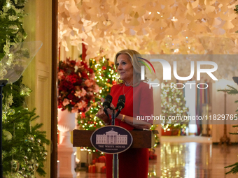 First Lady Dr. Jill Biden greets volunteers who help decorate the White House Christmas displays. Earlier in the day, she is asked if she su...