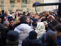 People crowd to get free bread in the Bustan Al-Qasr neighborhood in Aleppo, on December 1, 2024. (