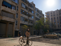 An old man drags his bicycle in the Bustan Al-Qasr neighborhood in Aleppo, Syria, on December 1, 2024. (