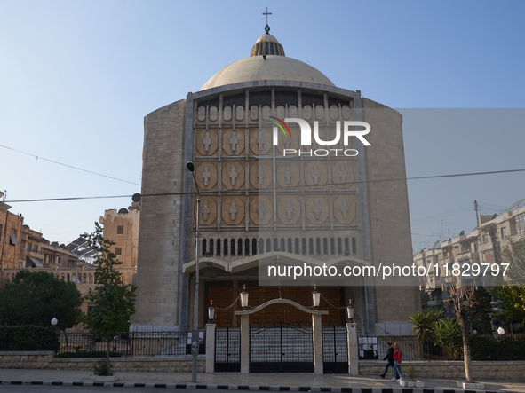 Residents walk near a church in Aleppo, Syria, after the armed opposition takes control of the city, on December 1, 2024.  